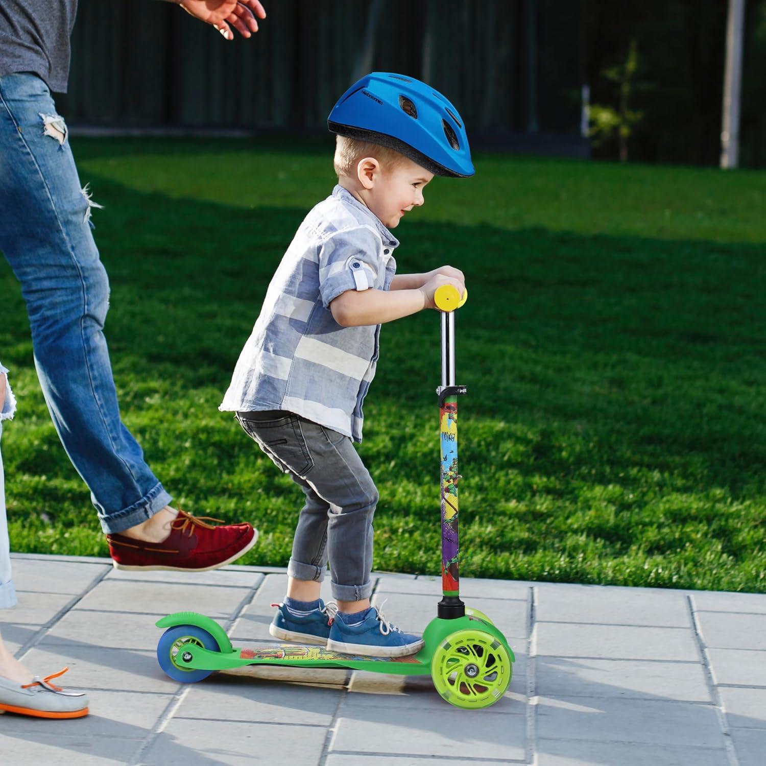 imageSelf Balancing Kick Scooter with Light Up Wheels Extra Wide Deck 3 Wheel Platform Foot Activated Brake 75 lbs Limit Kids amp Toddlers Girls or Boys for Ages 3 and UpTMNT