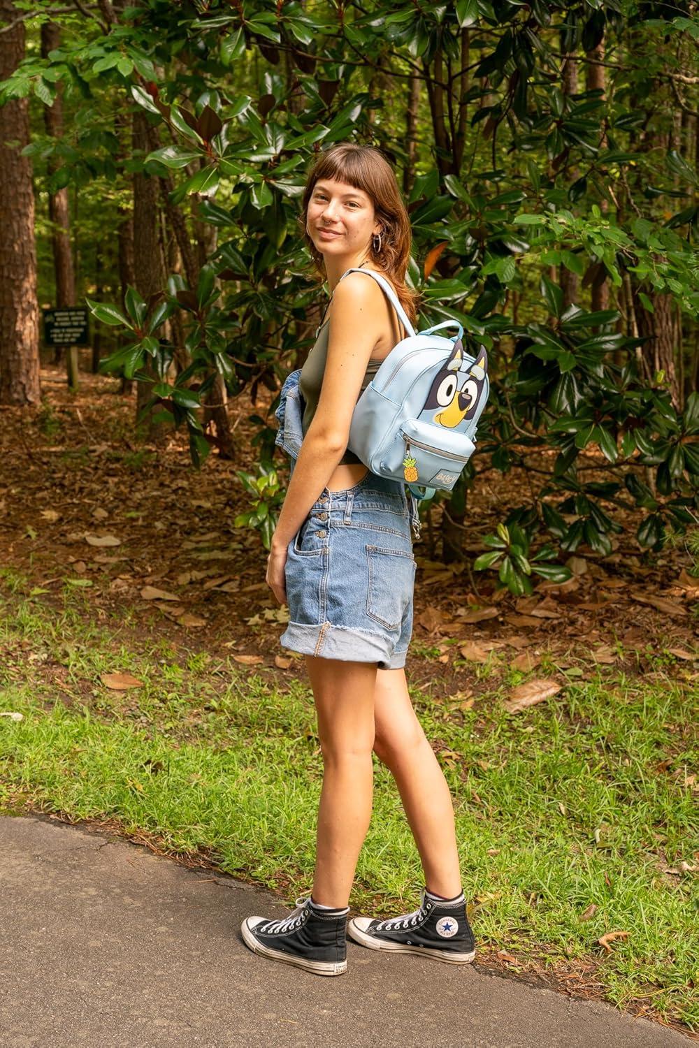 imageAI ACCESSORY INNOVATIONS Bluey Big Face Mini Cosplay PU Backpack Purse Shoulder Bag with Epoxy Filled Metal Pineapple Charm 105 Inch Adjustable Straps Faux LeatherBluey